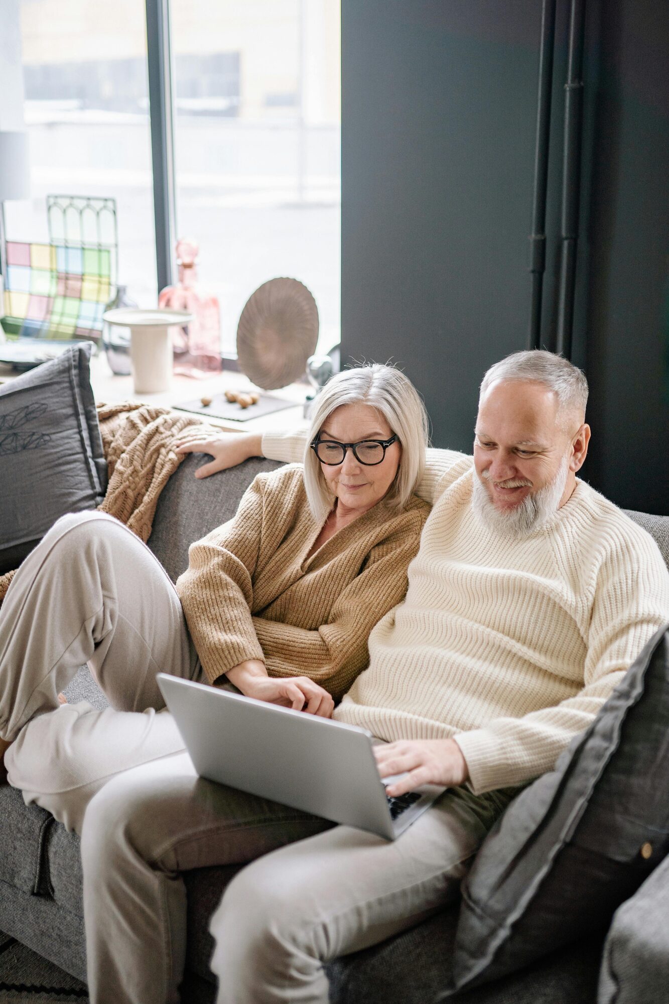 Retired couple planning together on a laptop at home