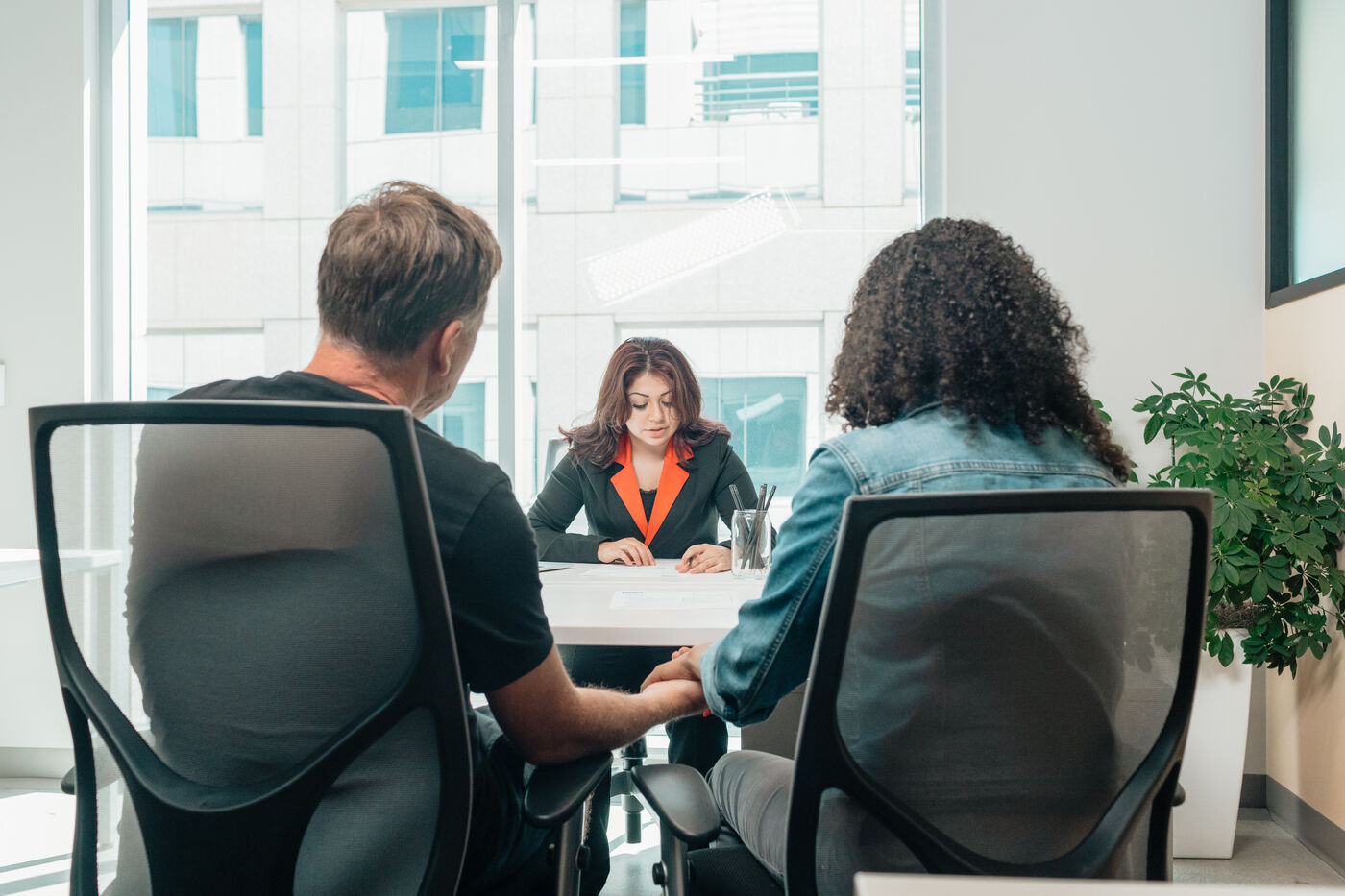 Financial advisor meeting with clients across a desk