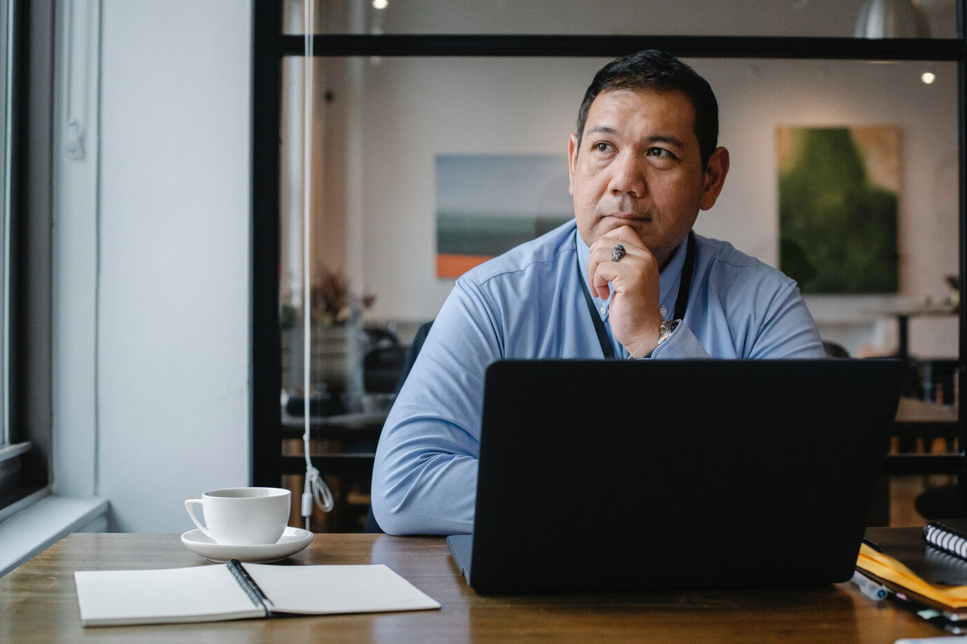 Employee thinking about retirement while working at a laptop